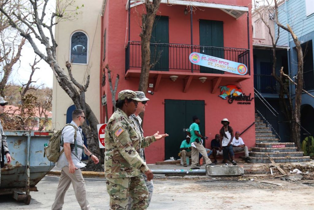 Troops assess the damage on Saint John while locals go about their day. Source: U.S. Department of Defense