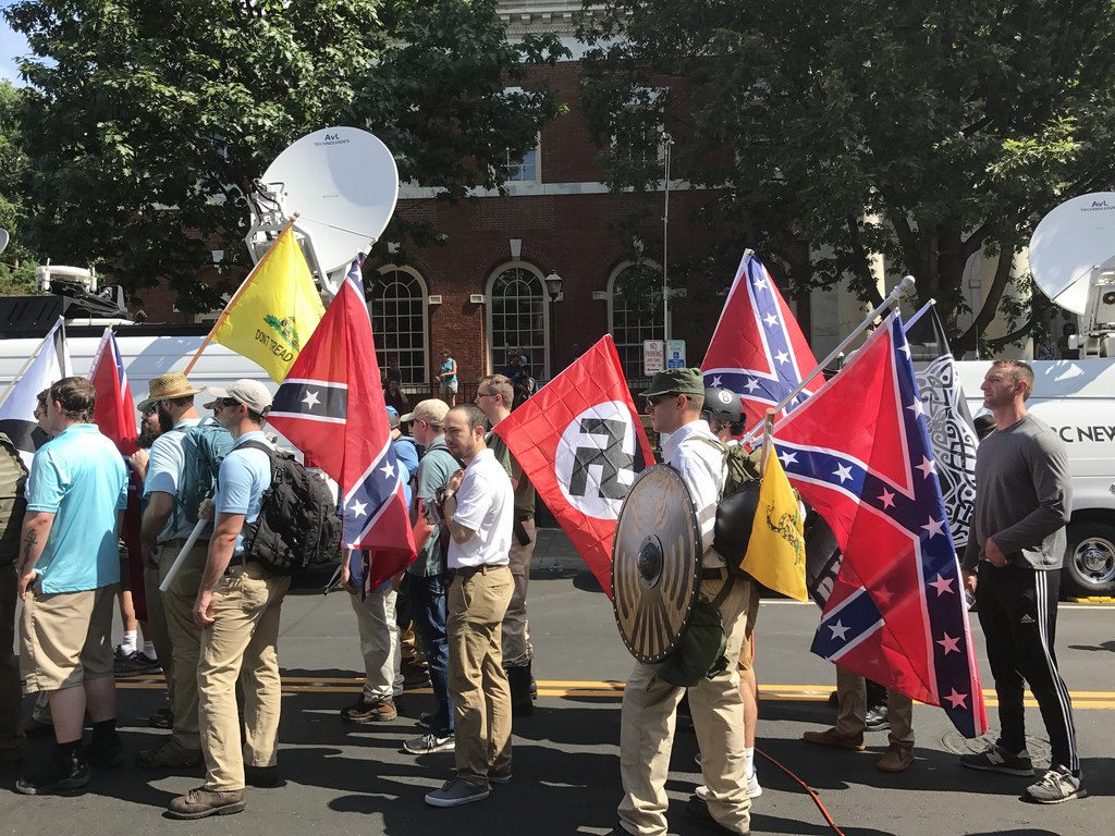 Participants in the Unite the Right Rally holding the Nazi, Confederate Battle, Gadsden "Don't Tread on Me," Southern Nationalist, and Thor's Hammer flags. (Source: Anthony Crider via Flickr)