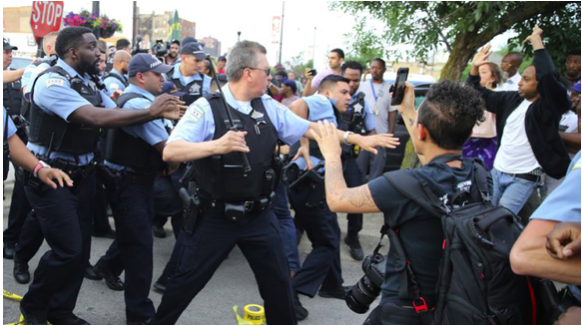 Chicago police officers scuffle with angry protestors where Harith Augustus was killed, July 14, 2018. Image Source: Nuccio DiNuzzo / Chicago Tribune