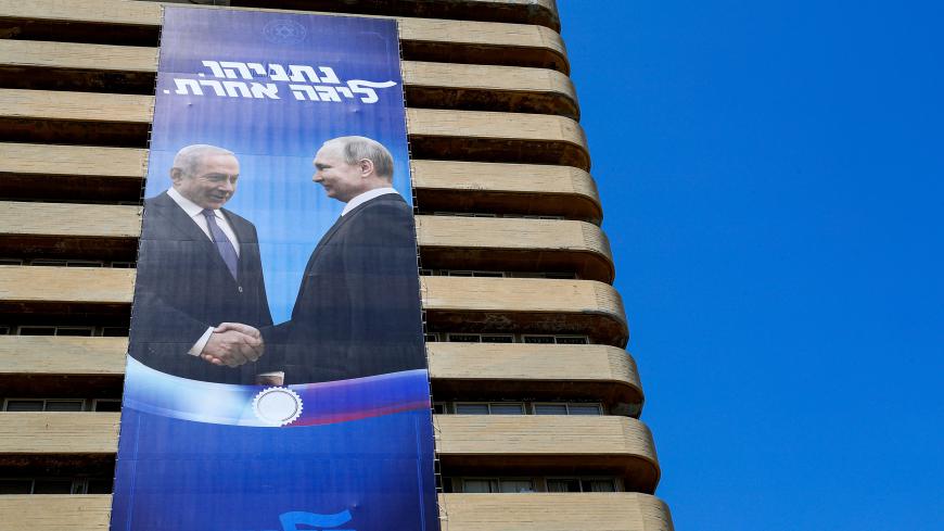 Billboard showing Putin and Bibi shaking hands
